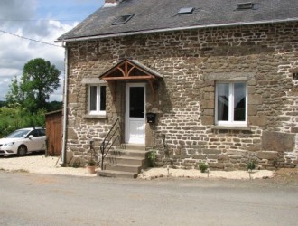 The front of the cottage, which has off-road parking to the side.