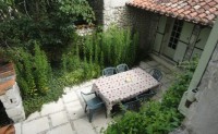 View from upstairs bedroom of the courtyard to the rear of the cottage: perfect for al fresco dining and barbeques!