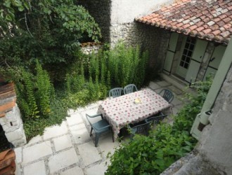 View from upstairs bedroom of the courtyard to the rear of the cottage: perfect for al fresco dining and barbeques!